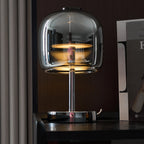 Zenviae Glow Jar Table Lamp glowing in modern dark-toned living room