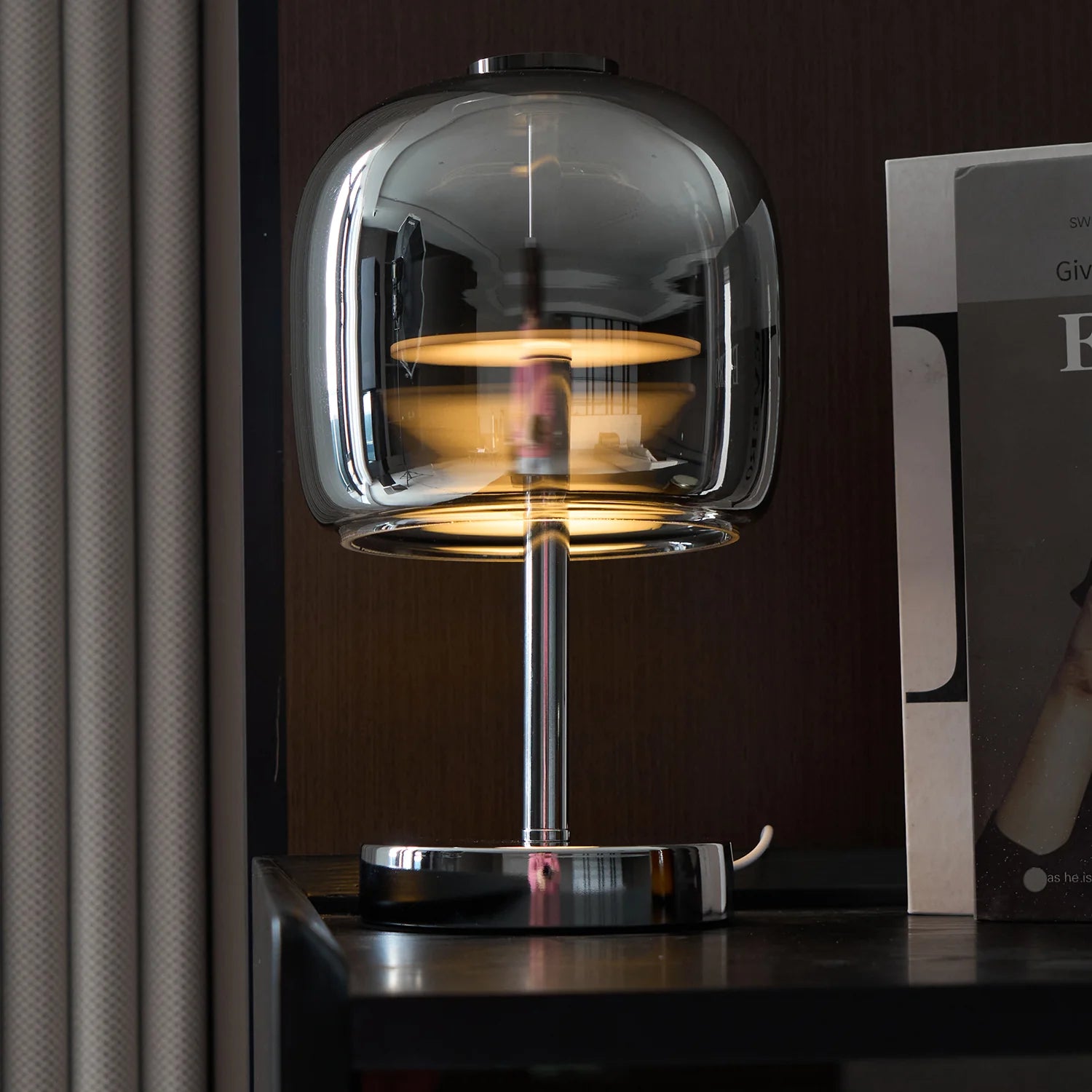 Zenviae Glow Jar Table Lamp glowing in modern dark-toned living room