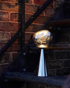 Zenviae Lava Charge Table Lamp in outdoor night scene with brick wall