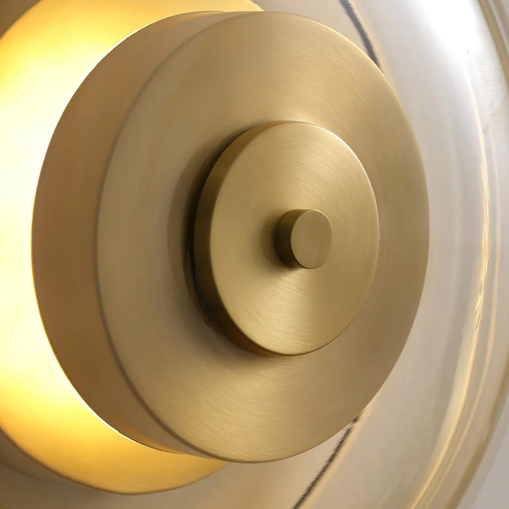 Zenviae Orbit Glow Wall Lamp detail of golden center and clear glass ring