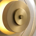 Zenviae Orbit Glow Wall Lamp detail of golden center and clear glass ring